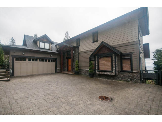 Furnished living room with large windows and stone fireplace. - Upper - 4407 Prospect Rd, North Vancouver