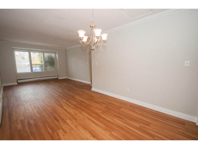 Bright living room with hardwood floors and a chandelier. - Upper - 113 W Kings Rd, North Vancouver