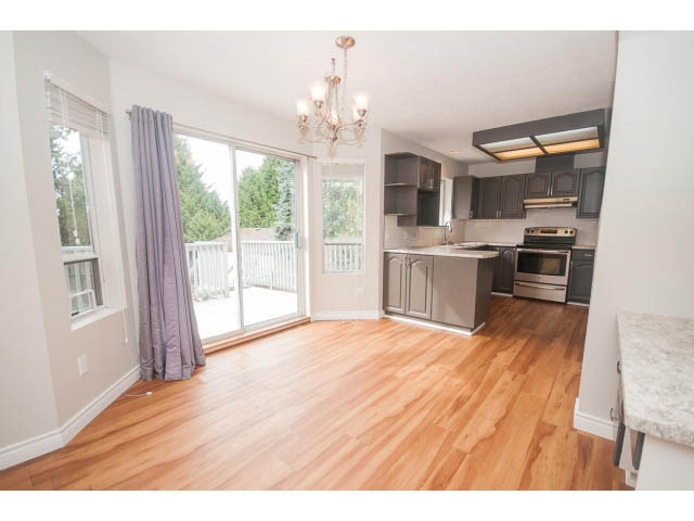 Bright kitchen with hardwood floors, granite countertops, and a city view. - Upper - 113 W Kings Rd, North Vancouver