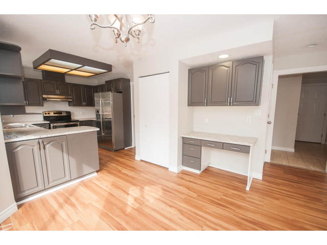 Bright kitchen with modern appliances, hardwood floors, and gray cabinets. - Upper - 113 W Kings Rd, North Vancouver