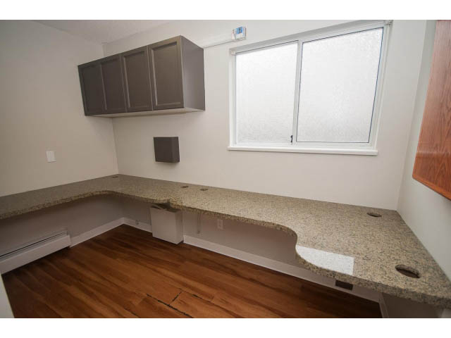 Bright kitchen with granite countertops, hardwood floors, and a large window. - Upper - 113 W Kings Rd, North Vancouver