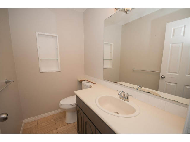 Bright bathroom with white countertop and sink, wooden floor. - Upper - 113 W Kings Rd, North Vancouver
