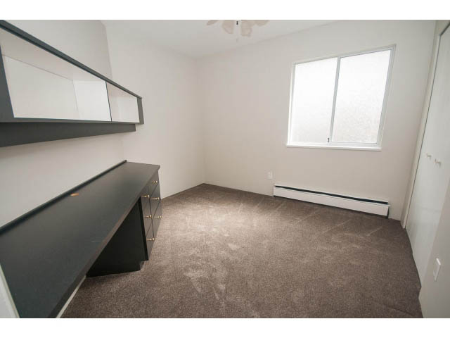 Bright den with dark countertops and carpeted floor, natural light from window. - Upper - 113 W Kings Rd, North Vancouver