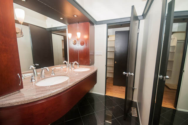 Furnished bathroom with granite countertops and hardwood floors. - 4645 Caulfeild Drive, West Vancouver