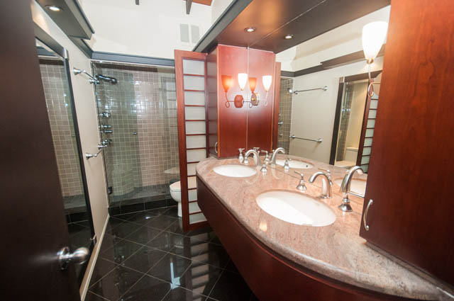 Modern bathroom with granite countertops and wooden accents. - 4645 Caulfeild Drive, West Vancouver