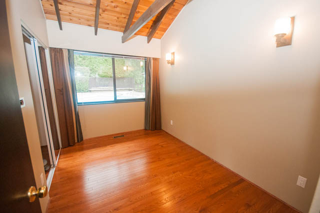 Bright living room with hardwood floors and large window view. - 4645 Caulfeild Drive, West Vancouver