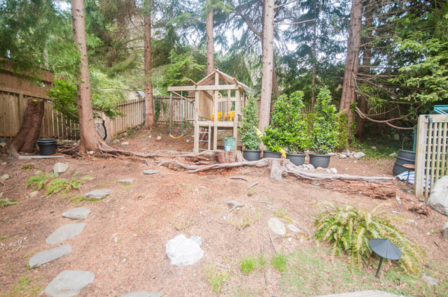 Playful backyard with swing set and potted plants. - 4645 Caulfeild Drive, West Vancouver