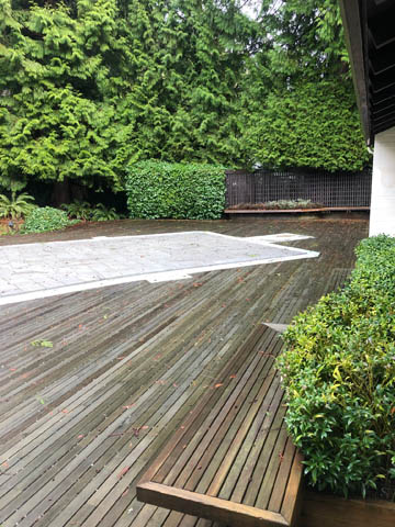 Furnished deck with wooden bench and lush greenery, perfect for relaxation. - 4645 Caulfeild Drive, West Vancouver