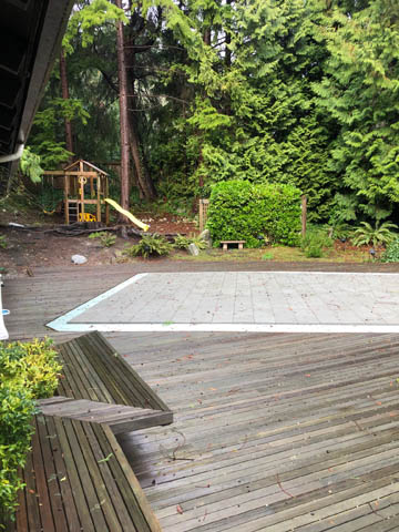 Furnished deck with wooden planks and a play area in the background. - 4645 Caulfeild Drive, West Vancouver