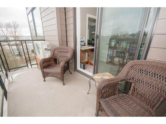 Furnished balcony with wicker furniture and city view. - 624 - 723 W 3rd St, North Vancouver