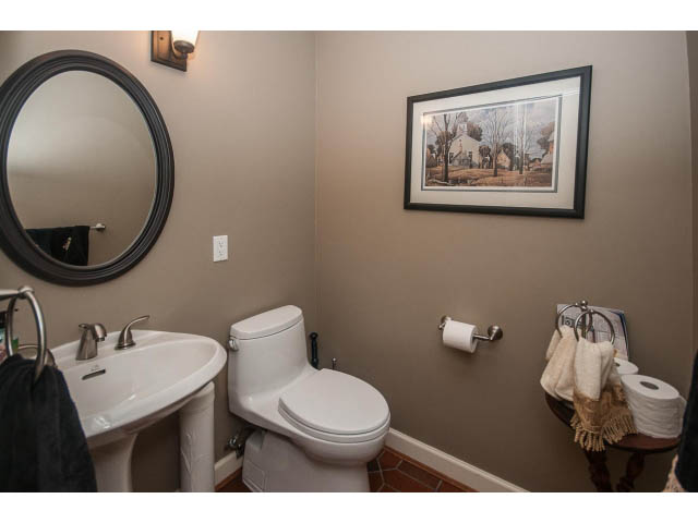 Bright bathroom with white fixtures and framed artwork. - 5237 Timberfeild Road, West Vancouver