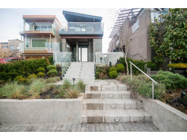 Modern 3-bedroom + den house with sleek glass railings and concrete steps leading to the entrance. - 2309 Bellevue Ave, West Vancouver
