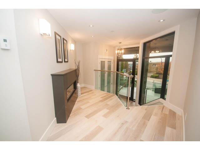 Bright entryway with hardwood floors and modern decor. - 2309 Bellevue Ave, West Vancouver