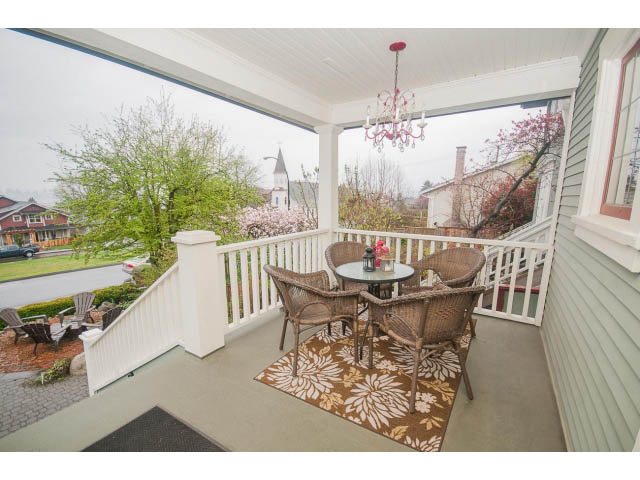 Furnished patio with outdoor furniture, chandelier, and city view. - 266 W 6th St, North Vancouver