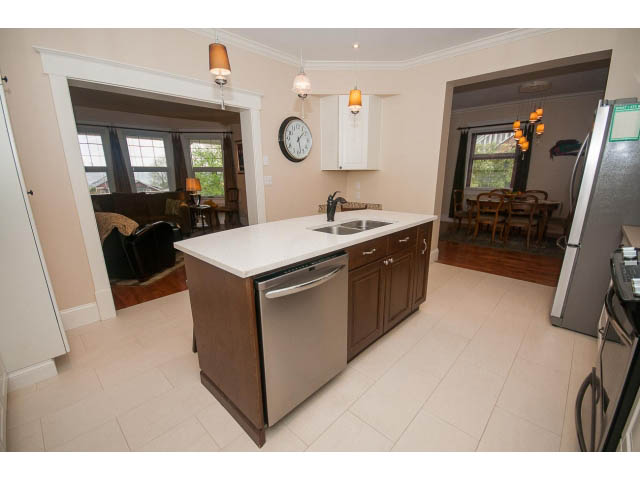 Bright kitchen with white countertops, hardwood floors, and a city view. - 266 W 6th St, North Vancouver