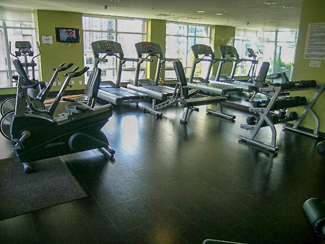 Fitness room with cardio equipment and large windows. - 1003 - 535 Smithe St, Vancouver Downtown