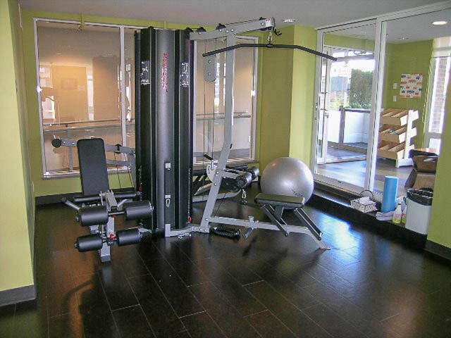 Bright gym with exercise equipment and large windows. - 1003 - 535 Smithe St, Vancouver Downtown