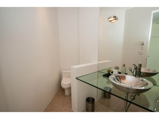 Furnished bathroom with glass countertop and modern sink. - 5517 Ocean Place, West Vancouver