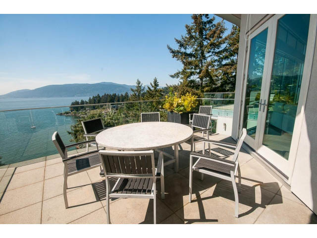 Furnished patio with ocean view and modern furniture. - 5517 Ocean Place, West Vancouver
