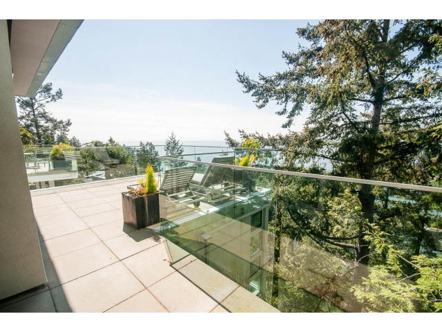 Bright balcony with glass railings, offering stunning ocean views. - 5517 Ocean Place, West Vancouver