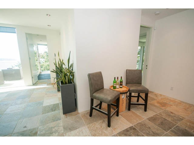 Bright dining area with stone countertops and city view. - 5517 Ocean Place, West Vancouver