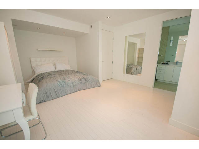Bright bedroom with white walls, hardwood floors, and a large closet. - 5517 Ocean Place, West Vancouver