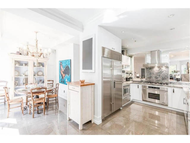 Bright kitchen with stainless steel appliances, marble countertops, and hardwood floors. - 1 - 2888 Birch Street, Vancouver West Side