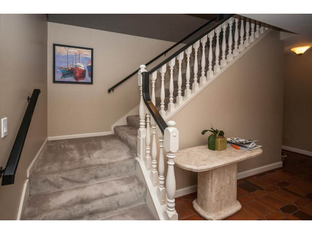 Furnished entryway with spiral staircase and decorative wall art. - Upper - 5237 Timberfeild Road, West Vancouver