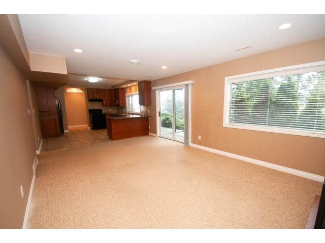 Spacious living room with large windows and hardwood floors. - Lower - 5237 Timberfeild Road, West Vancouver