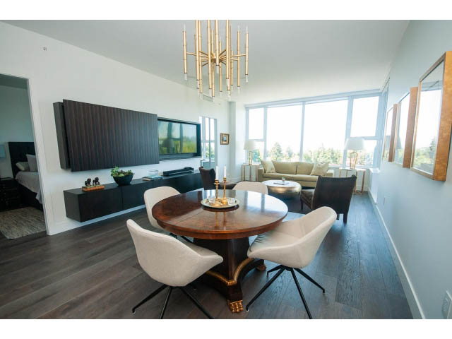 Furnished living room with hardwood floors, large windows, and a modern chandelier. - 511 - 2102 W 48th St, Vancouver West Side