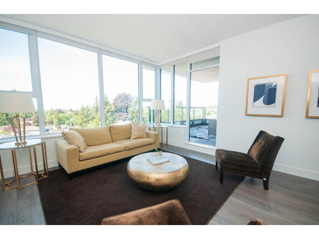 Bright living room with large windows, hardwood floors, and a city view. - 511 - 2102 W 48th St, Vancouver West Side