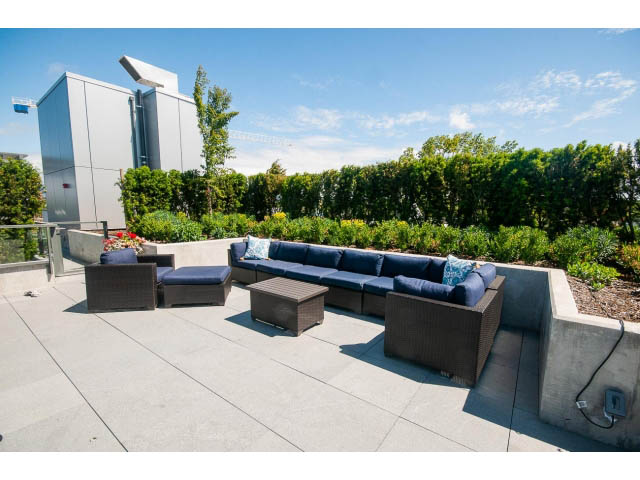 Furnished rooftop patio with modern furniture and lush greenery. - 511 - 2102 W 48th St, Vancouver West Side