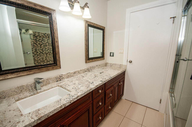 Spacious bathroom featuring granite countertops and dark wood cabinetry. - 5367 Esperanza Drive, North Vancouver