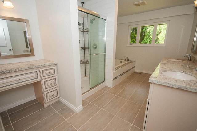 Spacious bathroom with granite countertops and frameless glass shower enclosure. - 5367 Esperanza Drive, North Vancouver
