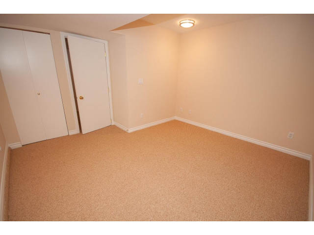 Empty bedroom with beige carpet and white walls. - 315 Stevens Dr, West Vancouver