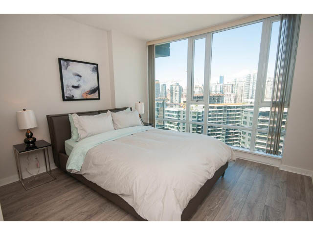 Bright bedroom with city view and modern furnishings. - 2702 - 918 Cooperage Way, Vancouver Downtown