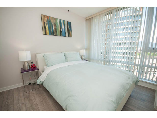 Bright bedroom with hardwood floors, city view, and modern decor. - 2702 - 918 Cooperage Way, Vancouver Downtown