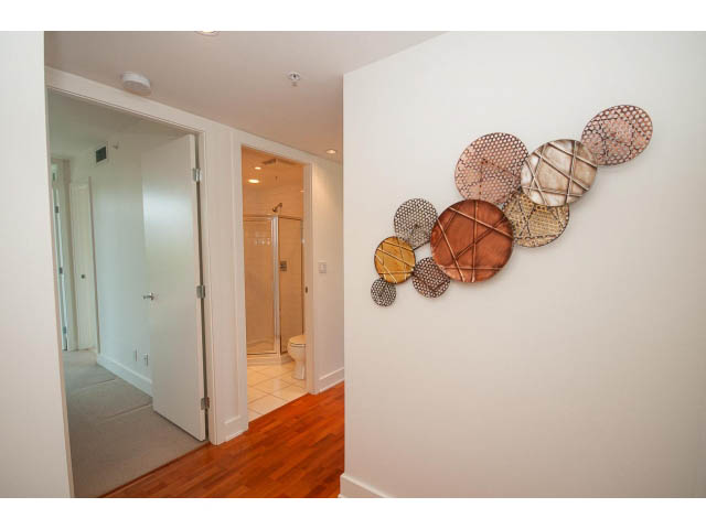 Furnished hallway with wooden floors and modern wall art. - 703 - 1863 Alberni Street, Vancouver Downtown