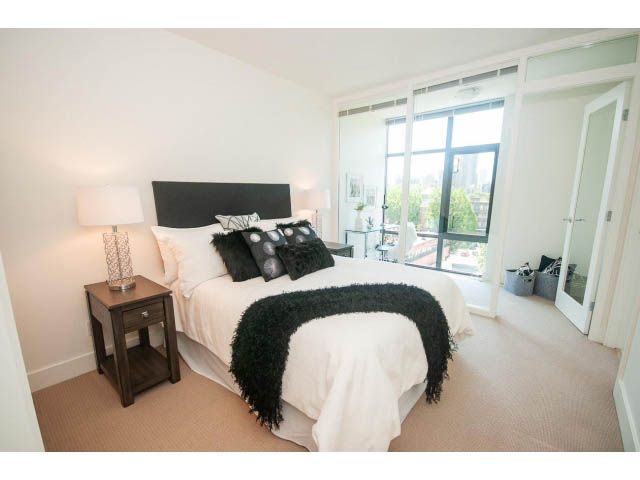 Bright bedroom with large windows, city view, and modern decor. - 703 - 1863 Alberni Street, Vancouver Downtown