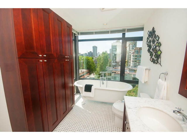 Spacious bathroom with large window, city view, and modern decor. - 703 - 1863 Alberni Street, Vancouver Downtown