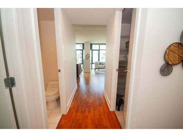 Furnished hallway with hardwood floors leading to a bright living area. - 703 - 1863 Alberni Street, Vancouver Downtown