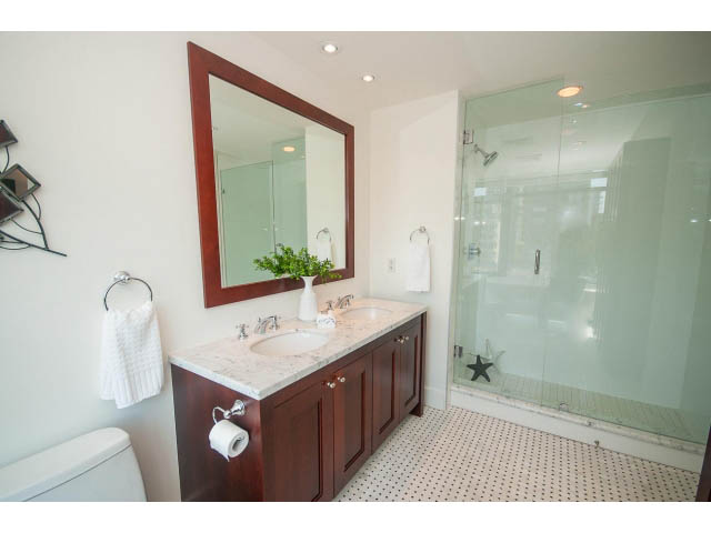 Furnished bathroom with white countertops and dark wood cabinets. - 703 - 1863 Alberni Street, Vancouver Downtown
