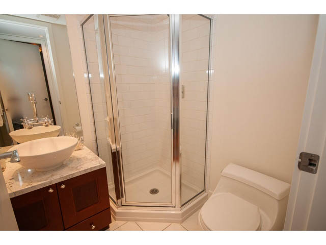 Bright bathroom with marble countertops and a corner shower. - 703 - 1863 Alberni Street, Vancouver Downtown