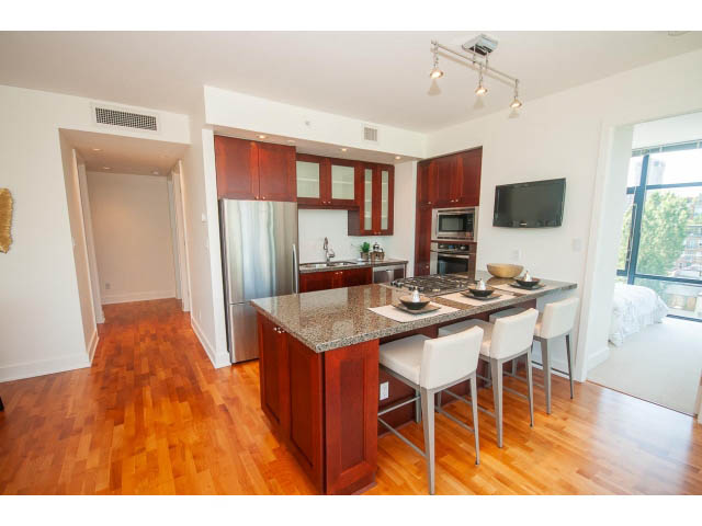 Bright kitchen with granite countertops, hardwood floors, and a city view. - 703 - 1863 Alberni Street, Vancouver Downtown