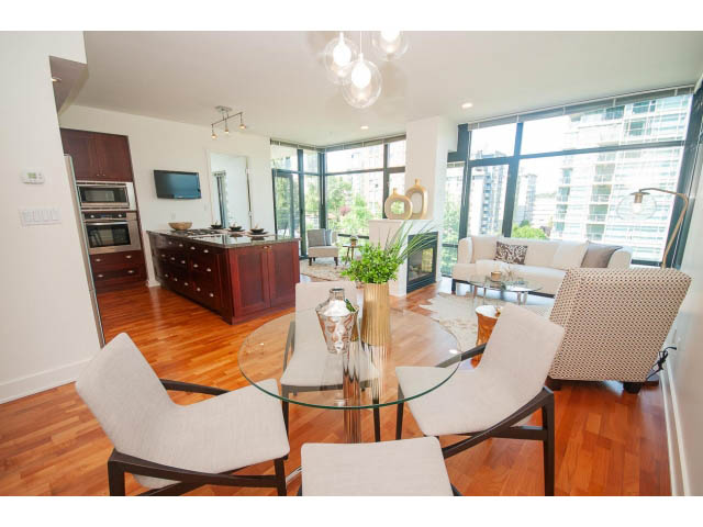 Bright dining and living area with hardwood floors, city view, and modern furnishings. - 703 - 1863 Alberni Street, Vancouver Downtown