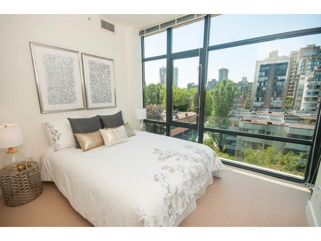 Furnished bedroom with large windows, city view, and modern decor. - 703 - 1863 Alberni Street, Vancouver Downtown