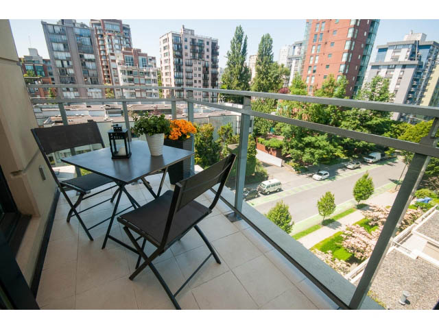 Furnished balcony with city view, outdoor dining set, and potted plants. - 703 - 1863 Alberni Street, Vancouver Downtown