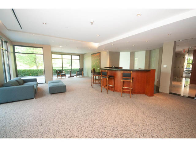Spacious living room with large windows, modern furniture, and a cozy corner. - 703 - 1863 Alberni Street, Vancouver Downtown