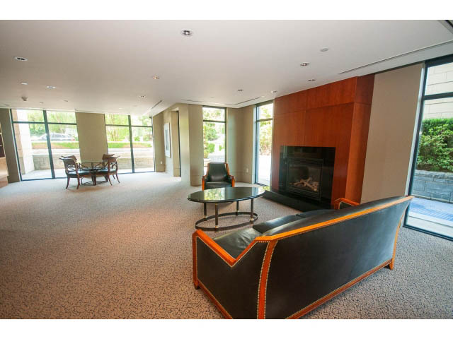 Furnished living room with large windows, modern furniture, and a fireplace. - 703 - 1863 Alberni Street, Vancouver Downtown