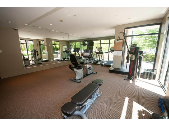 Spacious gym with cardio machines, mirrors, and natural light. - 703 - 1863 Alberni Street, Vancouver Downtown